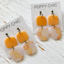 Load image into Gallery viewer, Handmade Orange Floral Polymer Clay Earrings with Bronze jump rings
